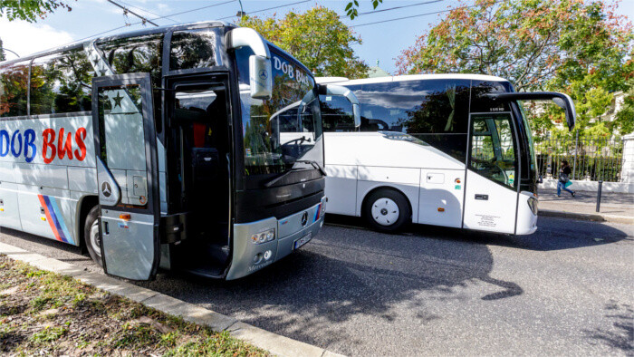 Discontented bus carriers block road outside Government Office 