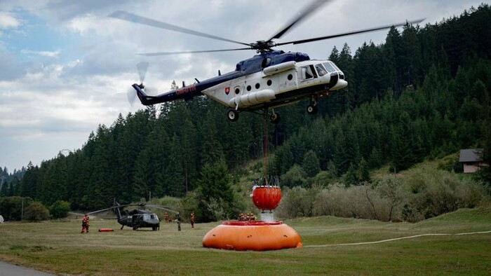 Firefighters putting out fire in Low Tatras, helped by helicopters